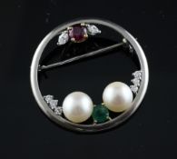 An 18ct white gold and gem set open work circular brooch, set with diamonds, cultured pearls, ruby