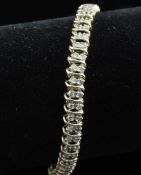 A modern 10ct gold and diamond line bracelet, set with one hundred diamonds, 7.25in.