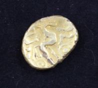 A British Celtic gold stater, c.70BC, crude Laureate head, reverse triple tailed horse, wheel below,