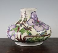 A Moorcroft floral compressed baluster vase, c.2001, decorated with pink orchids on a cream