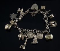 A 9ct gold charm bracelet, with heart shaped padlock, hung with fourteen mainly gold charms, gross