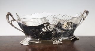 A large WMF Art Nouveau silvered pewter and glass centrepiece, with female figure, scrolling