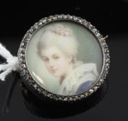 A 19th century gold, silver and diamond chip set circular brooch, with inset painted bust of a lady,