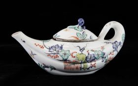 A French Kakiemon pattern teapot and cover, of rare boat shape, painted with a squirrel amid
