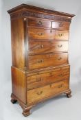 A George III mahogany chest on chest, of two short and three long drawers, with brushing slide and