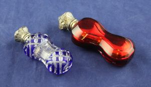 Two late Victorian silver mounted ruby or blue flash glass scent bottles, of waisted form, unmarked,