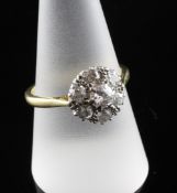 An 18ct gold, platinum and diamond cluster ring, of flowerhead design set with seven stones, size