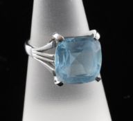 A 14ct white gold and blue topaz dress ring, with pierced setting and shoulders, size O.