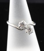 A platinum and two stone diamond crossover ring, the total diamond weight approximately estimated at