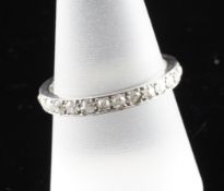 A white gold and diamond set full eternity ring, total diamond weight in excess of 1.0ct, size R.