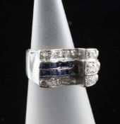 A 1940`s/1950`s 18ct white gold and platinum sapphire and diamond dress ring, size J.