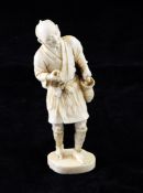 A Japanese ivory figure of a fisherman, holding a fish by a basket to his left side, lacking a net