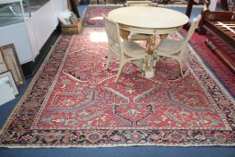 A Hamadan carpet, with field of geometric foliate motifs, on a red ground, with three row border,