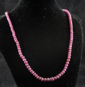 A single strand graduated ruby bead necklace, with gilt metal clasp, 18in.