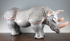 Jennie Hale. A large raku pottery standing figure of a rhinoceros, with grey and salmon pink