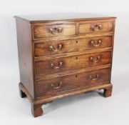 A George III mahogany chest, of two short and three long graduated drawers with brass ring