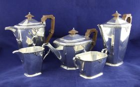 A George V octagonal silver five piece tea and coffee set, of tapering form, with decorated
