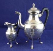 A continental French Empire style silver coffee pot and matching cream jug, with bird`s head