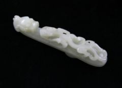 A Chinese pale celadon jade `dragon` belt hook, 18th / 19th century, carved in open work with a