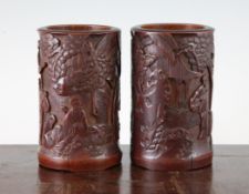 A pair of Chinese bamboo brush pots, Bitong, late 19th / early 20th century, each carved in high