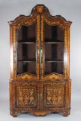 A 19th century Dutch marquetry inlaid corner cabinet with two glazed doors over two cupboard