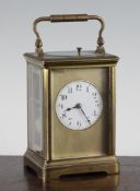 An early 20th century French brass hour repeating carriage clock, with circular arabic dial and