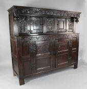 A 17th/18th century Lincolnshire carved oak court cupboard, fitted an arrangement of panels and