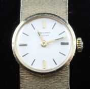 A lady`s 1970`s 9ct gold Record De Luxe manual wind wrist watch, with baton numerals, on integral