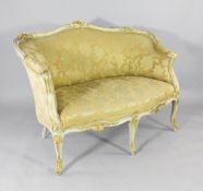 A French Louis XV style cream painted and parcel gilt canape, with yellow patterned upholstery