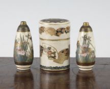 A Satsuma pottery box and a similar pair of vases, Meiji period, the cylindrical box decorated