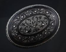 An early 20th century silver and tortoiseshell pique brooch, of oval form, with foliate