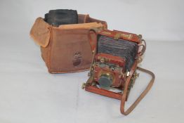 A Thornton Picard Royal ruby mahogany folding plate camera, with Goerz lens, with various camera