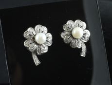 A pair of white gold diamond and cultured pearl set earrings, each modelled as a flower, 1in.