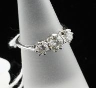 An 18ct white gold graduated three stone diamond ring, the total diamond weight estimated in