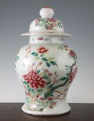 A Chinese famille rose baluster vase and cover, 19th century, painted with flowers and rock work,