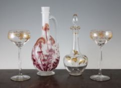 A Bohemian Art Nouveau gilt decorated glass decanter and stopper, and two similar slender glasses,