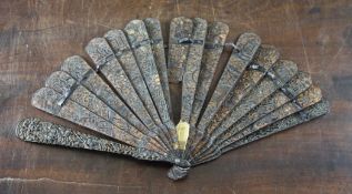 A Chinese export tortoiseshell brise fan, 19th century, the sticks carved with a continuous scene of