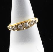 An early 20th century gold and graduated six stone diamond half hoop ring, with old cut stones and