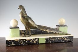 An Art Deco patinated model of a asiatic pheasant, with white onyx spheres on square plinths, 20.