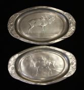 A large oval Kayserzinn pewter dish, decorated with two goats, marked 4621, together with a