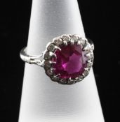 A white gold, ruby and diamond cluster ring, size K.