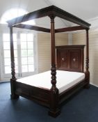 A 17th century style mahogany four poster bed, the headboard with blind fret carved panels and stiff