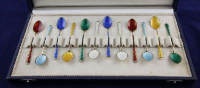 A cased set of twelve mid 20th century Danish sterling silver gilt and polychrome guilloche enamel