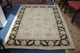 A Ziegler style rug, with field of foliate motifs on a beige ground, with black ground foliate