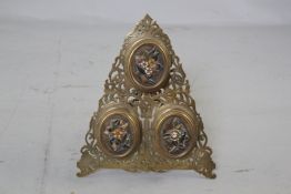 A Victorian engraved brass and hardstone triple easel photograph frame, 9in.