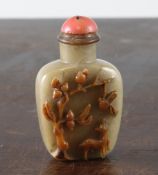A Chinese chalcedony cameo snuff bottle, of grey stone, carved in high relief to a russet layer in
