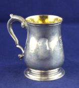 A George II silver baluster mug, with engraved armorial and acanthus leaf capped scroll handle, John