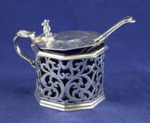 A Victorian pierced silver octagonal mustard pot, with engraved armorial and foliate decoration,