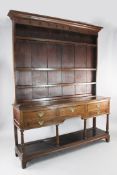 A 19th century oak dresser, with raised four shelf rack, three frieze drawers and pot board, W.5ft
