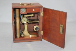 A Victorian lacquered brass microscope, by F. Cox of Newgate Street, London, with a fitted